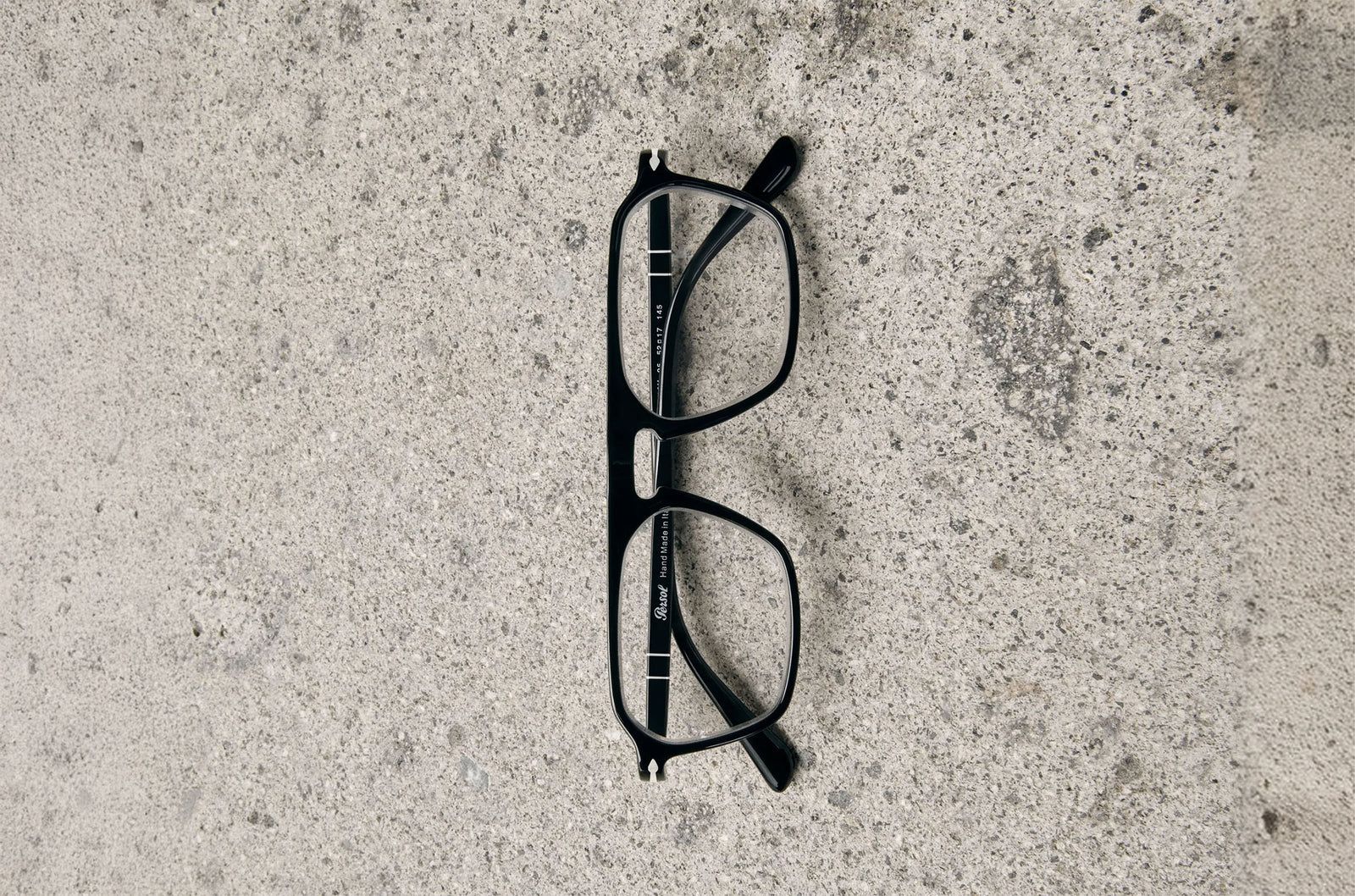 Persol optical frame resting on stone